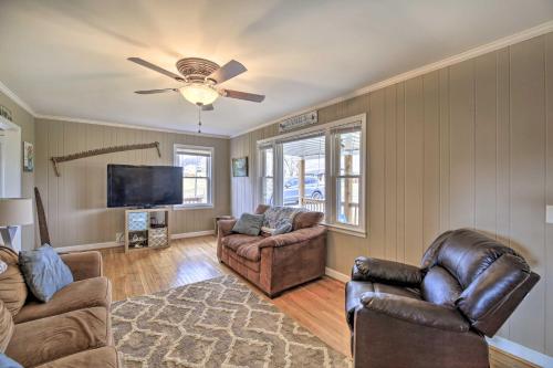 a living room with two chairs and a flat screen tv at Beautiful Views and Gas Grill Sparta Getaway! in Sparta