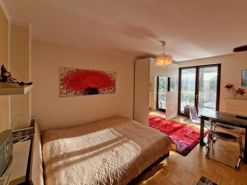 ドレスデンにあるFerienwohnung Arlettのベッドルーム1室(ベッド1台付)が備わります。壁には絵画が飾られています。