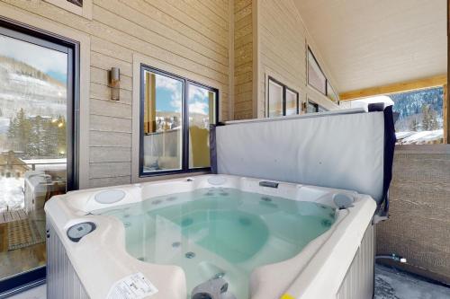 a large bath tub in a room with a window at Luxurious Escape in Durango Mountain Resort
