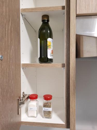 a bottle of wine is sitting in a pantry at Feel like Home! in Langford