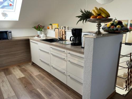 a kitchen with a counter with a bowl of fruit on it at Villa Florentine in Bad Liebenstein