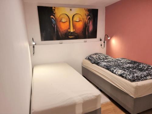 a room with two beds and a painting on the wall at Neu renoviert - Gemütliche Wohnung - 30 min bis Hamburg & Ostsee in Grönwohld