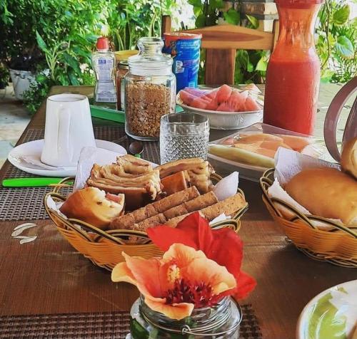 a table with baskets of food on a table at Pousada dos Anjos Paracuru in Paracuru