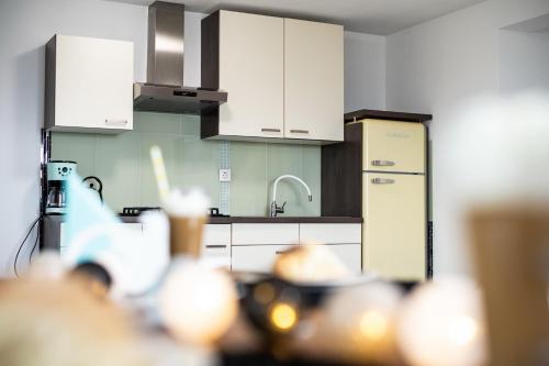 a kitchen with white cabinets and a sink at Four Points in Vir
