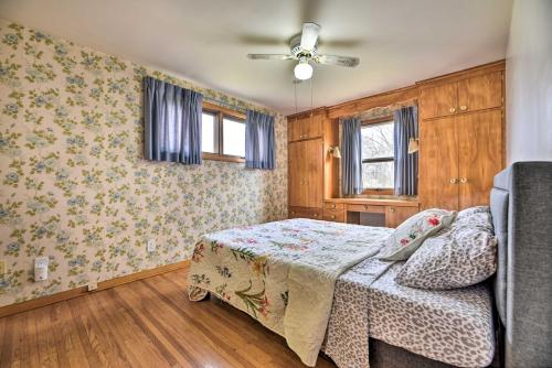 a bedroom with a bed and a ceiling fan at Vacation Rental about 8 Mi to KeyBank Center! in Buffalo