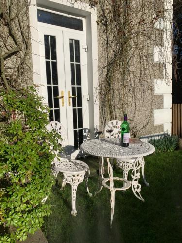 a table and two chairs with a bottle of wine at Tullyard House in Tullaghoge