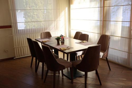 a dining room with a table and chairs at Hotel Happy in Dimitrovgrad