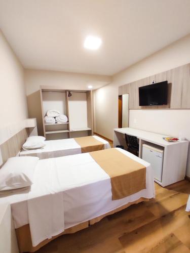 Ein Bett oder Betten in einem Zimmer der Unterkunft Harbor Querência Hotel