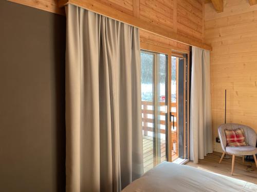 a bedroom with a bed and a large window at Chalet Tannegg in Saas-Fee