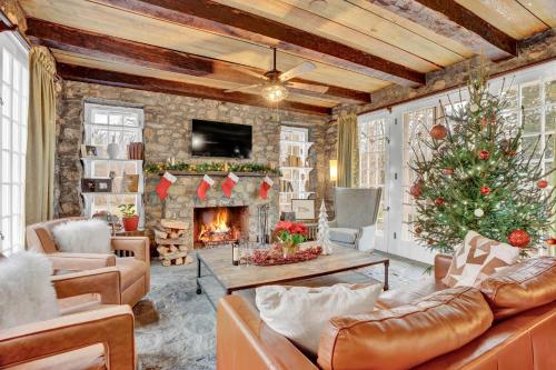 a living room with a christmas tree and a fireplace at Chimney Hill Estate Inn in Lambertville