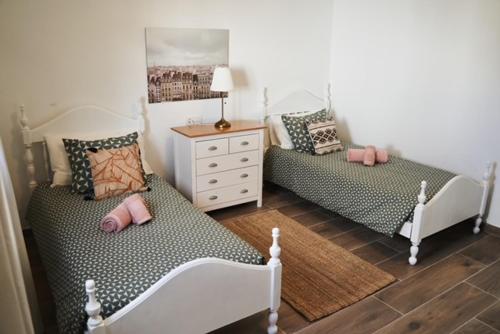 a bedroom with two beds and a dresser at CASA MINGO in Teguise