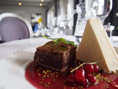 a piece of chocolate cake and cherries on a plate at Munkebo Kro & Hotel in Munkebo