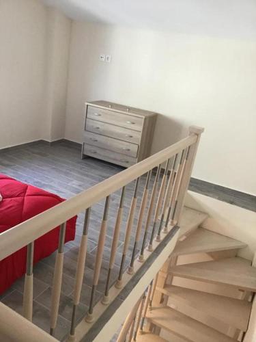 a staircase leading to a bedroom with a bed and a dresser at Anna House in Nikiti