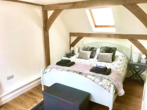 een slaapkamer met een wit bed op zolder bij The Clock House in Canterbury