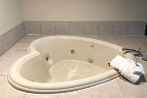 a bath tub in a bathroom with a towel at Quality Inn & Suites Boone - University Area in Boone