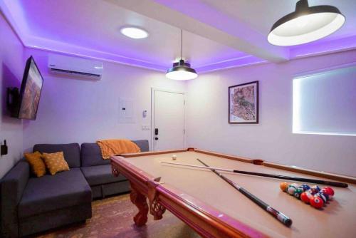 a living room with a pool table and a couch at Quail Cottage Clarkdale-Renovated Historic Cottage Sedona Jerome Wineries in Clarkdale