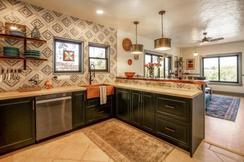 a kitchen with green cabinets and a counter top at Quail Cottage Clarkdale-Renovated Historic Cottage Sedona Jerome Wineries in Clarkdale