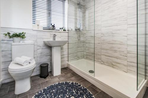 a bathroom with a toilet and a sink and a shower at 2 Bed Townhouse with Free Parking in Nottingham