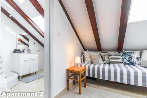 a bedroom with a bed in a attic at Valentina Apartments Vodice in Vodice