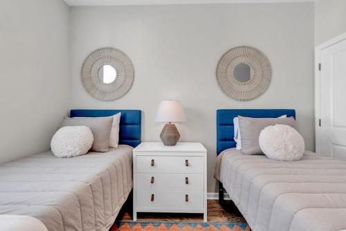 two beds sitting next to each other in a room at Centrally Located Myrtle Beach House Near Sports Center, Broadway at the Beach, Shopping, Beach, and Golf in Myrtle Beach