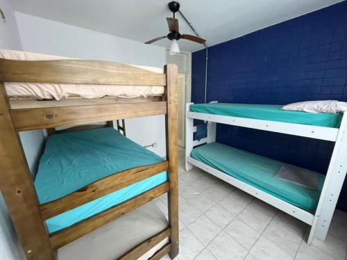 two bunk beds in a room with a blue wall at Pousada Linda In Ipanema in Rio de Janeiro