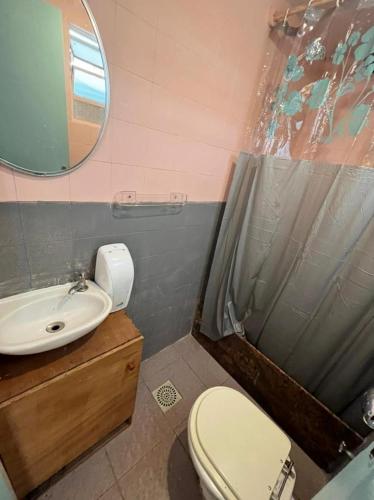 a bathroom with a toilet and a sink and a mirror at Pousada Linda In Ipanema in Rio de Janeiro