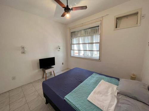 a bedroom with a bed and a flat screen tv at Pousada Linda In Ipanema in Rio de Janeiro