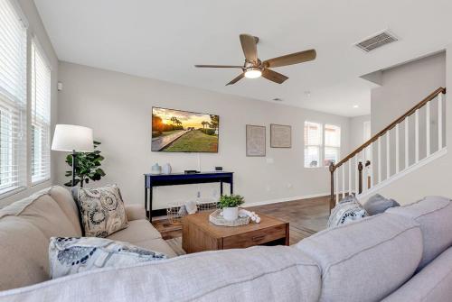 a living room with a couch and a piano at Centrally Located Myrtle Beach House Near Sports Center, Broadway at the Beach, Shopping, Beach, and Golf in Myrtle Beach