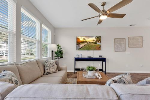 a living room with a couch and a ceiling fan at Centrally Located Myrtle Beach House Near Sports Center, Broadway at the Beach, Shopping, Beach, and Golf in Myrtle Beach