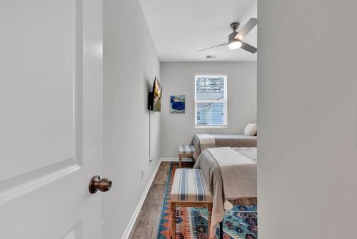 a bedroom with two beds and a window at Centrally Located Myrtle Beach House Near Sports Center, Broadway at the Beach, Shopping, Beach, and Golf in Myrtle Beach