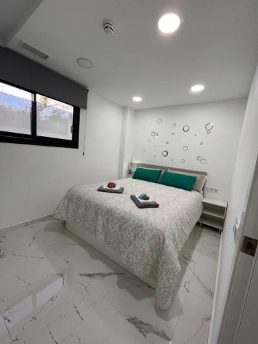 a bedroom with a bed in a white room at Apartamentos Rosa de Abril in Teià