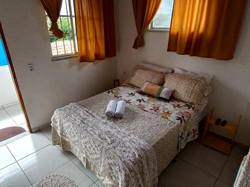 a bedroom with a bed with two towels on it at Hospedaria da Praia Fortaleza in Fortaleza