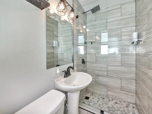 a white bathroom with a sink and a shower at Dania Beach Holiday Retreat International Airport in Dania Beach