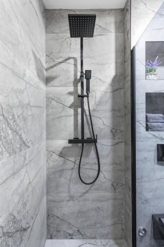 a shower with a shower head in a bathroom at Luxury room Ekstaza in Solin
