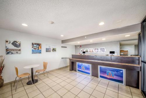 a restaurant with a bar with two chairs and a counter at Studio 6-Corpus Christi, TX - North in Corpus Christi