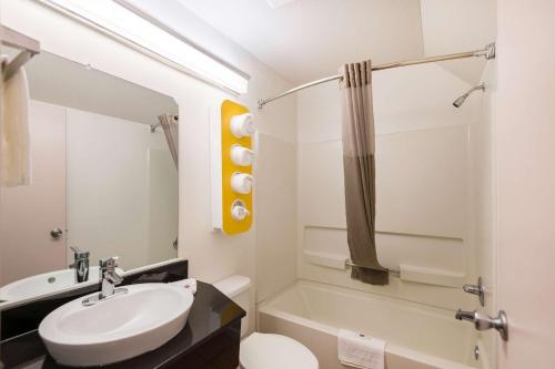 a bathroom with a sink and a toilet and a tub at Motel 6-Olathe, KS in Olathe