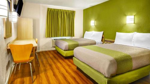 a hotel room with two beds and a desk at Lakeside Inn Lake Havasu City in Lake Havasu City