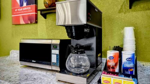 a coffee maker sitting on a counter next to a microwave at Lakeside Inn Lake Havasu City in Lake Havasu City