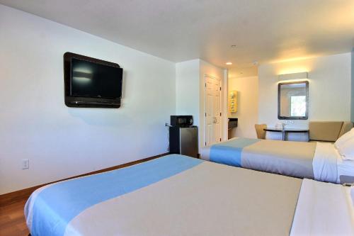 a hotel room with two beds and a flat screen tv at Motel 6-Rockport, TX in Rockport