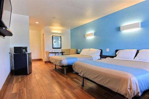 a hotel room with two beds and a television at Motel 6-Rockport, TX in Rockport