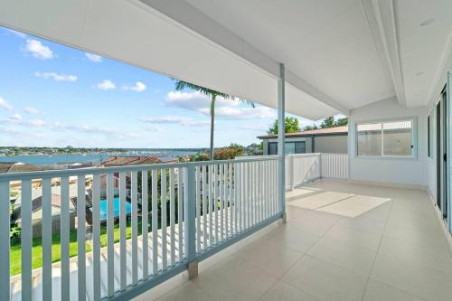 a balcony with a view of the water at Sky Home - Two Bedroom Loft Townhouse with Bay Views in Sydney