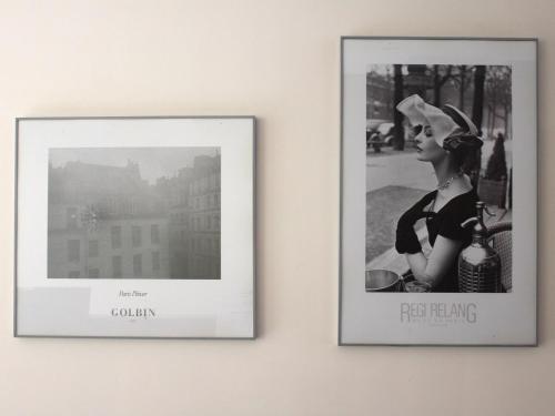 two framed photographs of a woman on a wall at New Hotel Saint Lazare in Paris