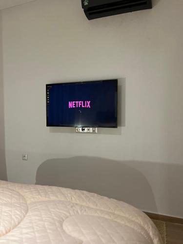 a television on a wall in a bedroom at Oujda in Oujda