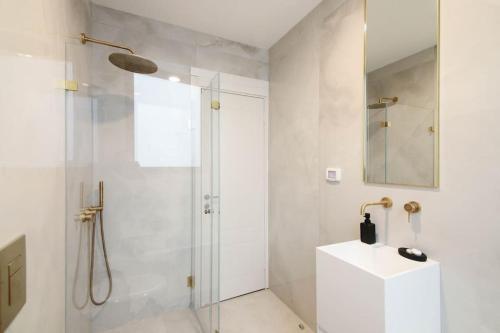 a white bathroom with a shower and a sink at Amazing View...2 bedroom apt J tower in Jerusalem