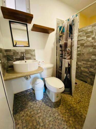 a bathroom with a toilet and a sink at HOTELITO SAN IGNACIO in San Ignacio