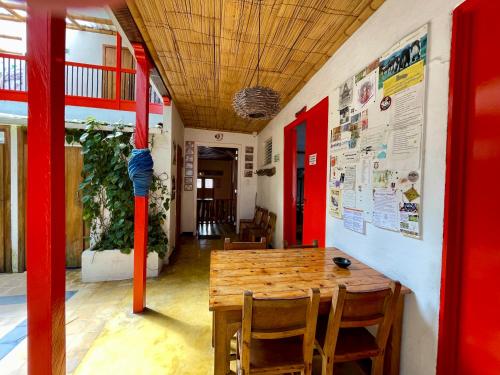 a dining room with a wooden table and chairs at Hostal Tralala Salento in Salento