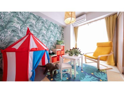 a dog standing in a room with a tent at Hotel Best Price Kochi - Vacation STAY 17530v in Kochi