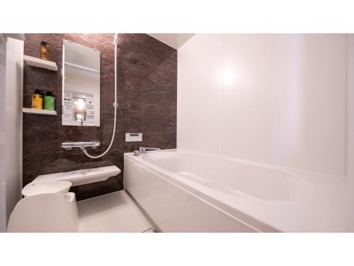 a bathroom with a white tub and a toilet at Hotel Best Price Kochi - Vacation STAY 17530v in Kochi