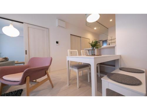 a living room with a white table and chairs at Hotel Best Price Kochi - Vacation STAY 17532v in Kochi