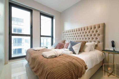 a bedroom with a large bed with a large window at Gorgeous 1 bedroom apt , J Tower in Jerusalem